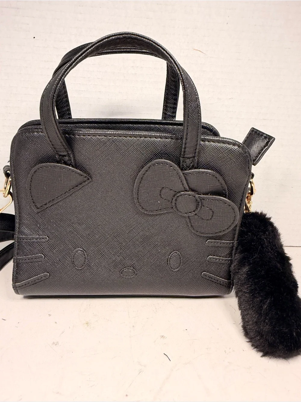 Sanrio Hello Kitty Black Faux Leather Crossbody Handbag with Pom Pom Charm